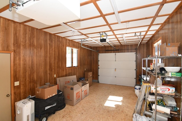 4331 N Burr Oak Rd, Lincoln, MI 48742 - garage with a garage door opener and wooden walls