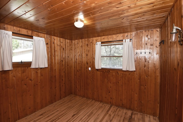 4331 N Burr Oak Rd, Lincoln, MI 48742 - spare room featuring wooden ceiling, wooden walls, and wood finished floors