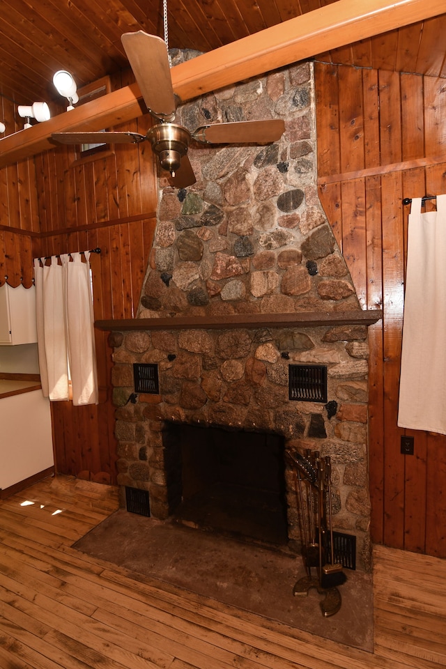 4331 N Burr Oak Rd, Lincoln, MI 48742 - unfurnished living room featuring a fireplace, hardwood / wood-style floors, wood ceiling, wooden walls, and ceiling fan