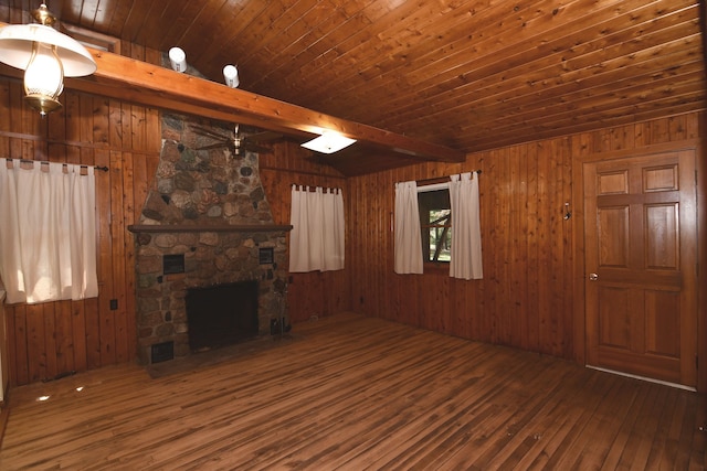 4331 N Burr Oak Rd, Lincoln, MI 48742 - unfurnished living room with hardwood / wood-style flooring, wood walls, wooden ceiling, a stone fireplace, and ceiling fan