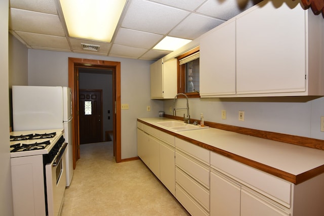 4331 N Burr Oak Rd, Lincoln, MI 48742 - kitchen with white appliances, a sink, a paneled ceiling, light countertops, and white cabinetry