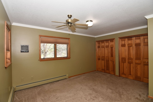 4331 N Burr Oak Rd, Lincoln, MI 48742 - unfurnished bedroom with baseboard heating, two closets, carpet floors, crown molding, and a textured ceiling