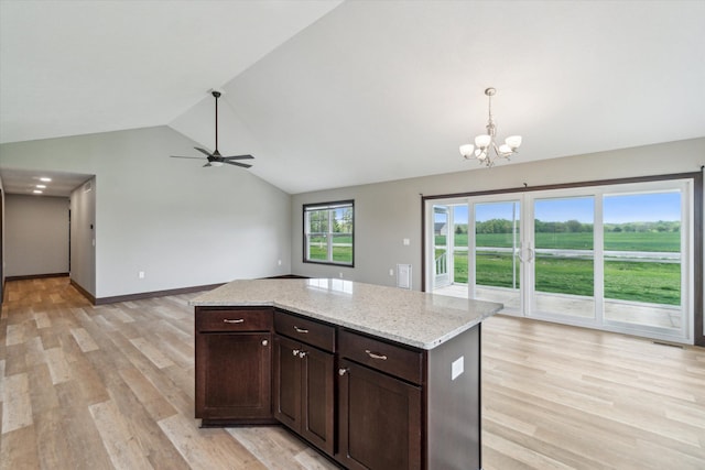 4050 Cayman Dr, Dewitt, MI 48820 - kitchen featuring a chandelier, vaulted ceiling, light wood-type flooring, dark brown cabinets, and decorative light fixtures