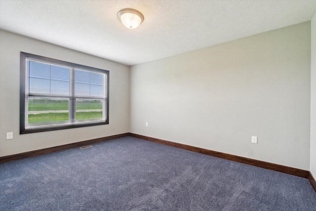 4050 Cayman Dr, Dewitt, MI 48820 - spare room featuring dark colored carpet and baseboards