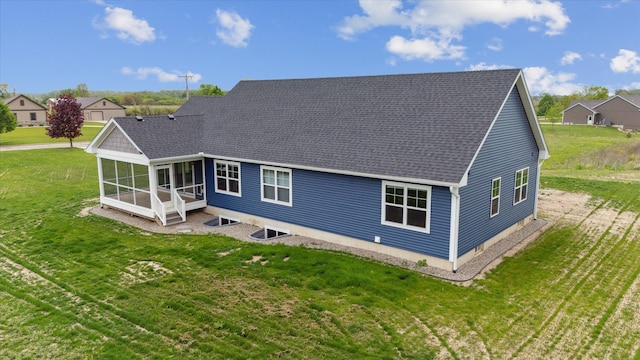 4050 Cayman Dr, Dewitt, MI 48820 - back of property featuring a sunroom, a lawn, and a shingled roof