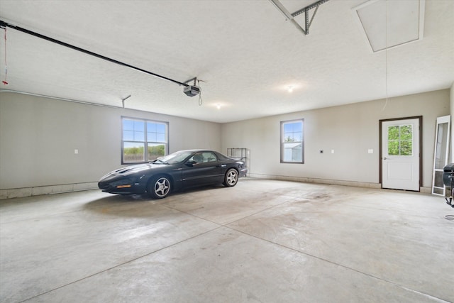 4050 Cayman Dr, Dewitt, MI 48820 - garage featuring a garage door opener