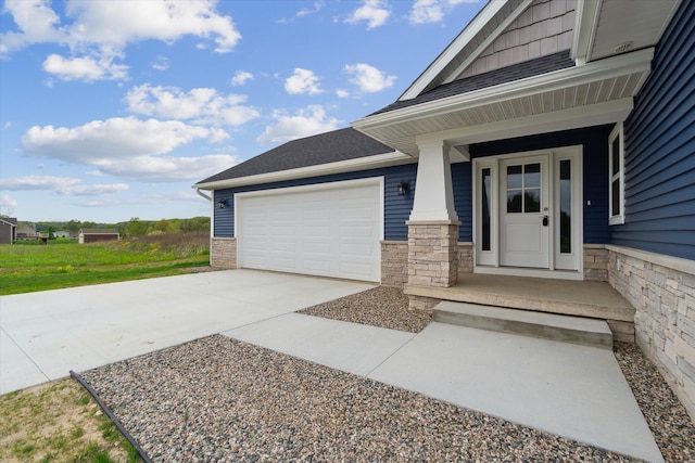 4050 Cayman Dr, Dewitt, MI 48820 - doorway to property featuring concrete driveway, an attached garage, stone siding, and roof with shingles