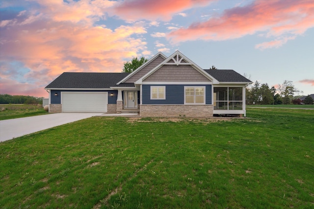 4050 Cayman Dr, Dewitt, MI 48820 - craftsman-style house with driveway, stone siding, an attached garage, a front lawn, and a sunroom