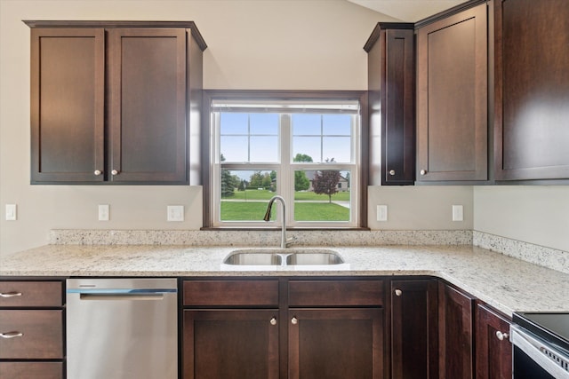 4050 Cayman Dr, Dewitt, MI 48820 - kitchen featuring a sink, appliances with stainless steel finishes, dark brown cabinetry, and light stone countertops