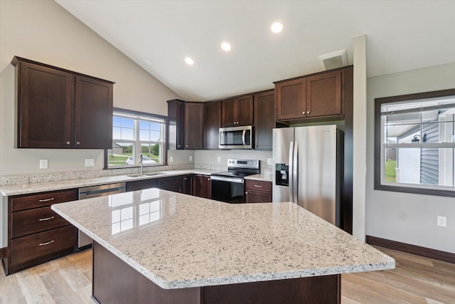 4050 Cayman Dr, Dewitt, MI 48820 - kitchen with stainless steel appliances, a sink, dark brown cabinetry, light wood-type flooring, and recessed lighting