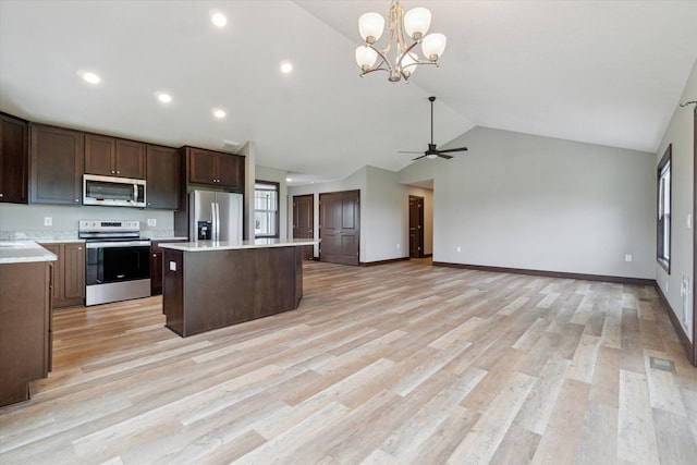 4050 Cayman Dr, Dewitt, MI 48820 - kitchen featuring stainless steel appliances, a center island, light countertops, dark brown cabinets, and a chandelier