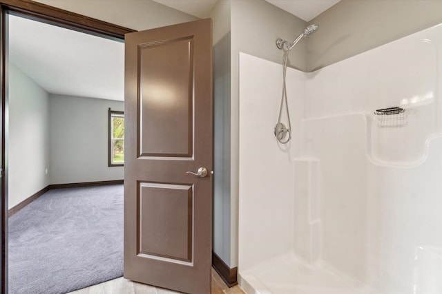 4050 Cayman Dr, Dewitt, MI 48820 - bathroom featuring a shower and baseboards
