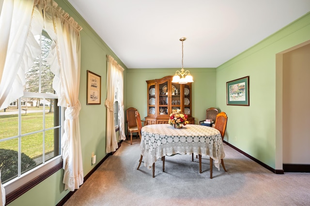 2266 Thunderbird Dr, Niles, MI 49120 - carpeted dining room featuring baseboards, ornamental molding, and an inviting chandelier