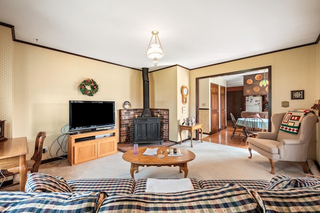 2266 Thunderbird Dr, Niles, MI 49120 - living room with wallpapered walls, carpet floors, ornamental molding, and a wood stove