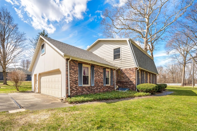 2266 Thunderbird Dr, Niles, MI 49120 - view of front of home with a gambrel roof, a front yard, concrete driveway, brick siding, and a garage