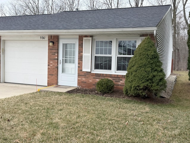 view of front of home with an attached garage, brick siding, a shingled roof, and a front lawn