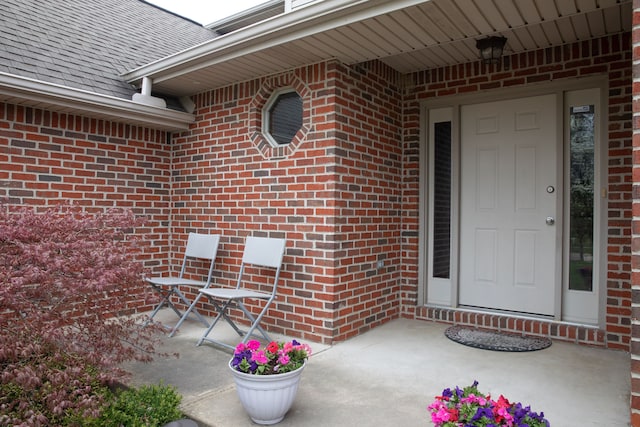448 Marblewood Ln, Saline, MI 48176 - view of exterior entry with brick siding and a shingled roof