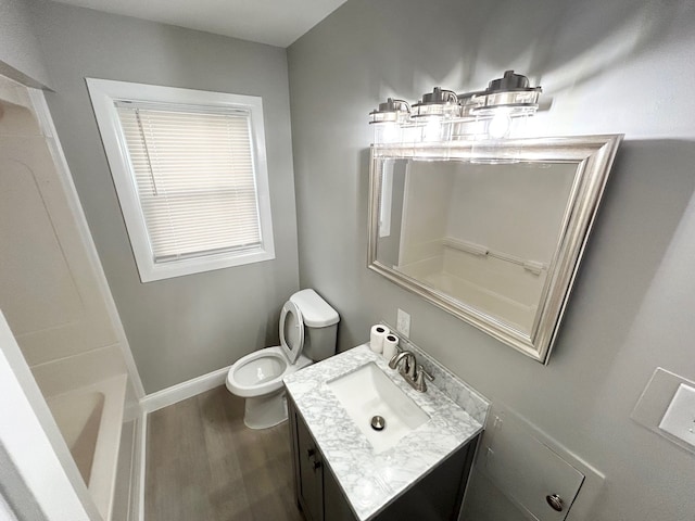 full bath featuring baseboards, toilet, wood finished floors, and vanity