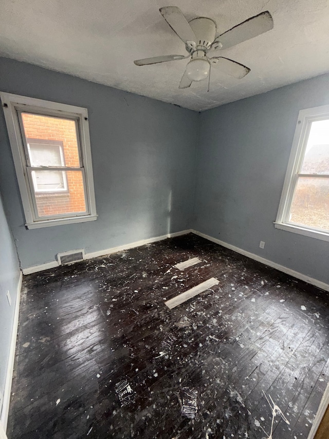 empty room with baseboards and a ceiling fan
