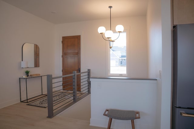 8120 Byron Depot Dr SW, Byron Center, MI 49315 - hall featuring an upstairs landing, wood finished floors, and a chandelier