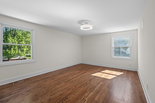 30728 W 14 Mile Rd, West Bloomfield, MI 48322 - spare room featuring healthy amount of natural light, dark wood-type flooring, and baseboards