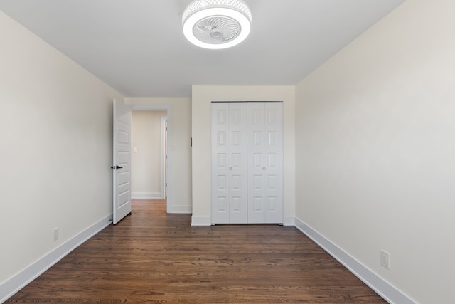 30728 W 14 Mile Rd, West Bloomfield, MI 48322 - unfurnished bedroom featuring baseboards, dark wood finished floors, and a closet