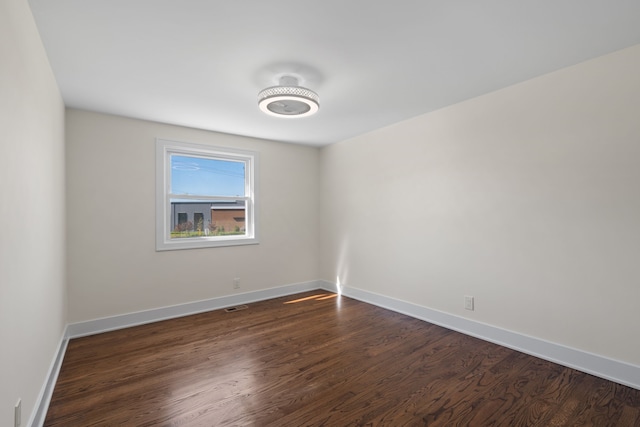 30728 W 14 Mile Rd, West Bloomfield, MI 48322 - spare room featuring dark wood-type flooring and baseboards