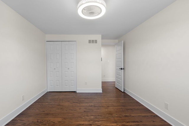 30728 W 14 Mile Rd, West Bloomfield, MI 48322 - unfurnished bedroom featuring baseboards, dark wood finished floors, and a closet