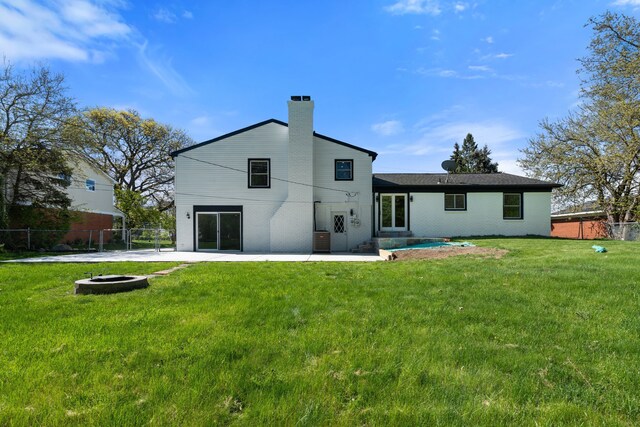 30728 W 14 Mile Rd, West Bloomfield, MI 48322 - rear view of house featuring an outdoor fire pit, a patio area, a chimney, and brick siding