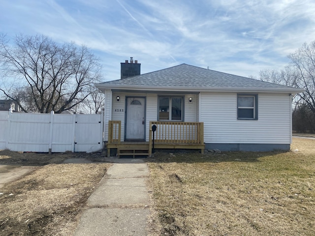 4543 Harriet St, Inkster, MI 48141 - bungalow-style home featuring a porch, roof with shingles, fence, a front lawn, and a chimney