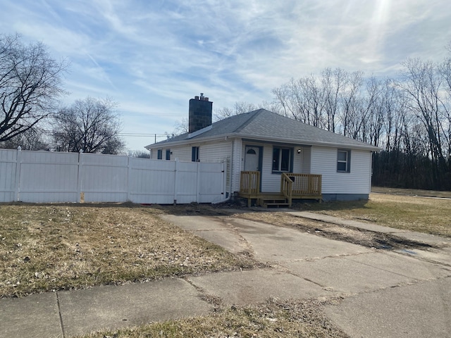 4543 Harriet St, Inkster, MI 48141 - view of front of property featuring a shingled roof, fence, covered porch, and a chimney