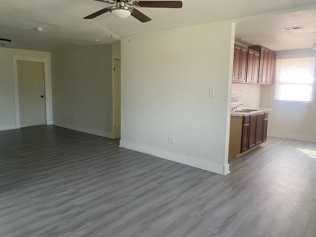 4543 Harriet St, Inkster, MI 48141 - empty room featuring dark wood-style flooring, visible vents, a ceiling fan, and a sink
