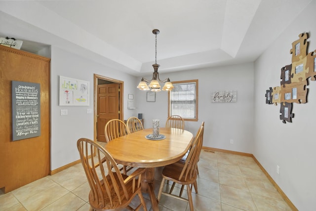 14073 Walz Blvd, Brooklyn, MI 49230 - dining area with light tile patterned floors, a tray ceiling, baseboards, and a notable chandelier
