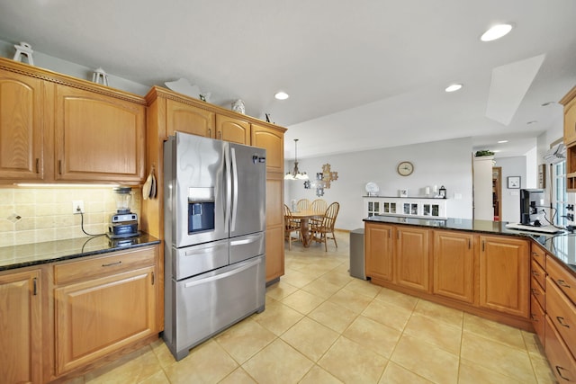 14073 Walz Blvd, Brooklyn, MI 49230 - kitchen with stainless steel fridge, light tile patterned floors, decorative backsplash, recessed lighting, and dark stone counters