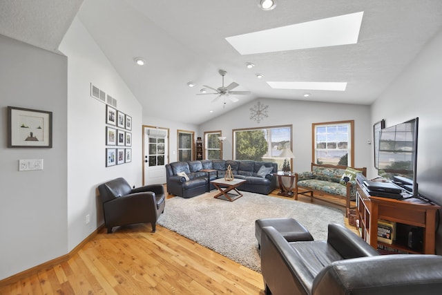 14073 Walz Blvd, Brooklyn, MI 49230 - living room with vaulted ceiling with skylight, light wood finished floors, baseboards, visible vents, and recessed lighting