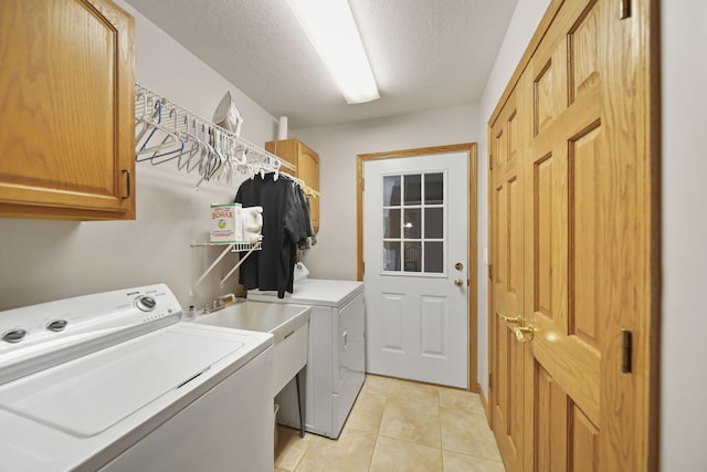 14073 Walz Blvd, Brooklyn, MI 49230 - washroom with light tile patterned floors, cabinet space, washer and dryer, and a textured ceiling