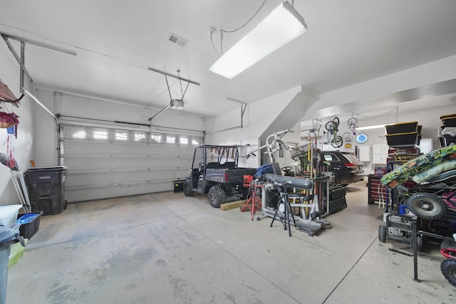 14073 Walz Blvd, Brooklyn, MI 49230 - garage with visible vents and a garage door opener
