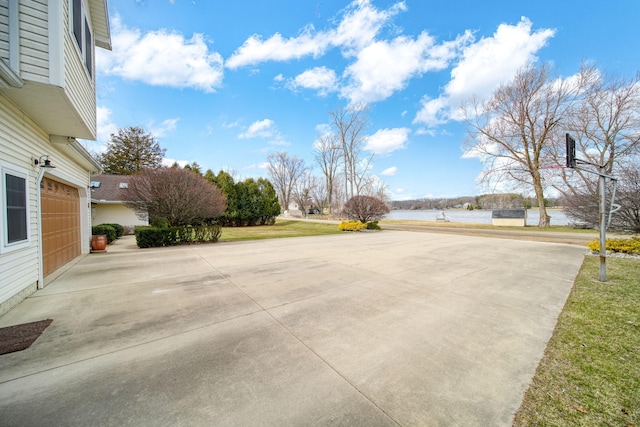 14073 Walz Blvd, Brooklyn, MI 49230 - view of patio with a water view, a garage, and concrete driveway