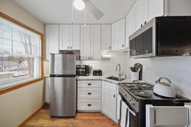 14073 Walz Blvd, Brooklyn, MI 49230 - kitchen featuring a sink, white cabinetry, tasteful backsplash, and appliances with stainless steel finishes