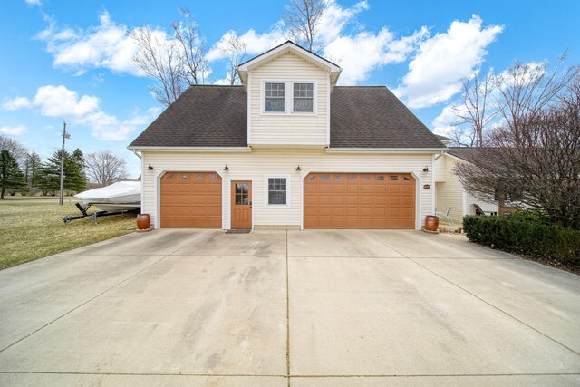 14073 Walz Blvd, Brooklyn, MI 49230 - view of side of home with roof with shingles, an attached garage, and concrete driveway