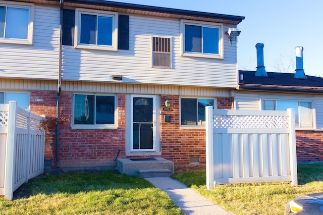 24951 Mayfair St Unit 20, Flat Rock, MI 48134 - view of front of home featuring fence and brick siding