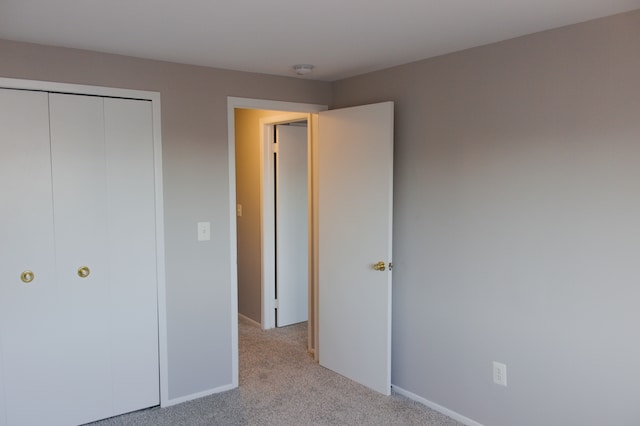 24951 Mayfair St Unit 20, Flat Rock, MI 48134 - unfurnished bedroom featuring baseboards, a closet, and carpet
