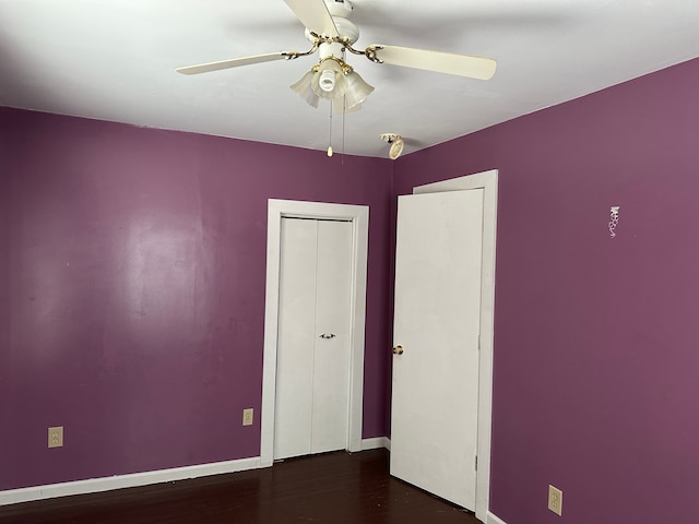 4469 Cooper Rd, Marlette, MI 48453 - unfurnished bedroom with a closet, dark wood-type flooring, baseboards, and ceiling fan
