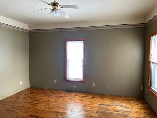 4469 Cooper Rd, Marlette, MI 48453 - spare room featuring visible vents, ceiling fan, and wood finished floors