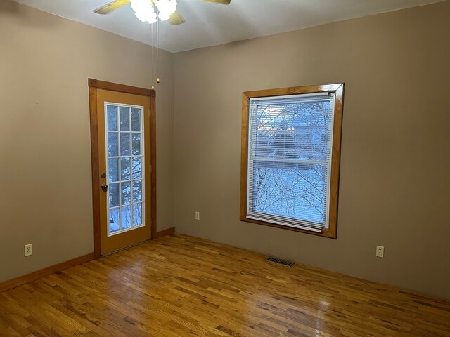 4469 Cooper Rd, Marlette, MI 48453 - empty room featuring visible vents, wood finished floors, and a ceiling fan