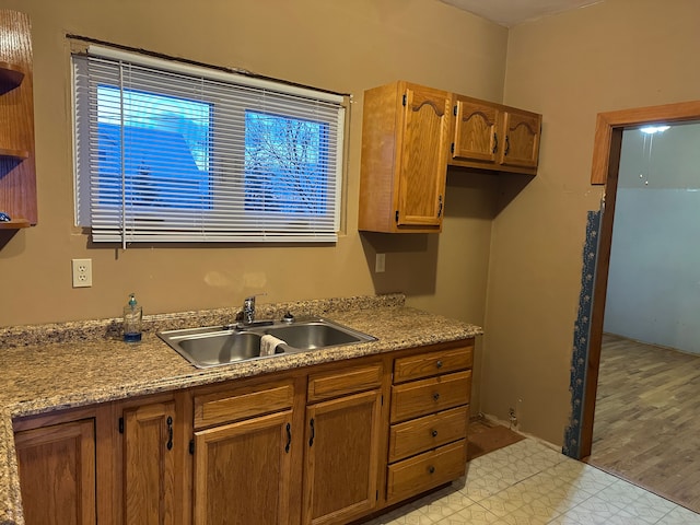 4469 Cooper Rd, Marlette, MI 48453 - kitchen with light floors, a sink, and brown cabinets