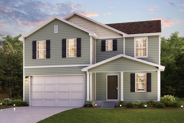 traditional home featuring a yard, an attached garage, a shingled roof, and driveway