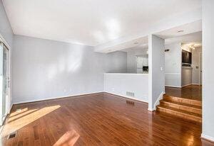 spare room featuring wood finished floors and baseboards