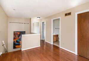 interior space with baseboards, wood finished floors, and visible vents