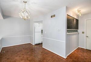 unfurnished dining area featuring baseboards, visible vents, and a notable chandelier